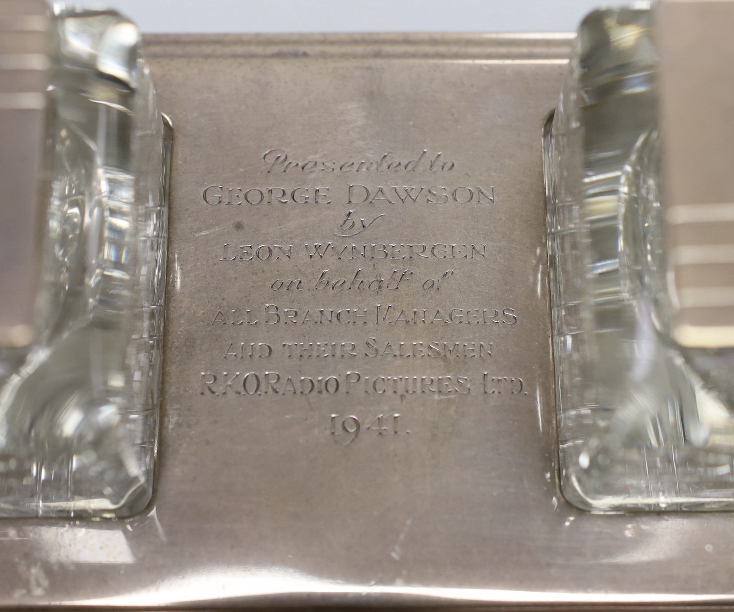 A George VI Art Deco silver presentation rectangular inkstand, with two mounted glass wells, with engraved inscription, Mappin & Webb, Sheffield, 1939, 22.2cm, base 14.8oz.